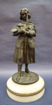 A bronze figure of Joan of Arc, with head bowed clutching a sword, on a circular marble base, 27.
