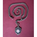 A silver and enamel medallion on a silver double Albert chain,
