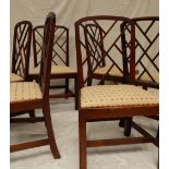 A set of six George III mahogany dining chairs, the beaded arched backs with fretted infill,