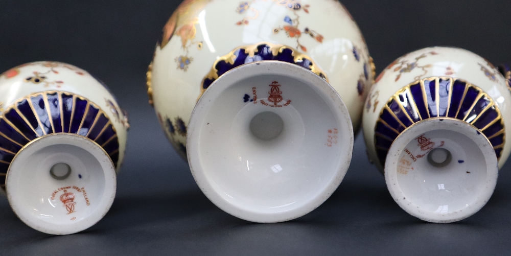 A Royal Crown Derby garniture of three vases with domed covers the body decorated with flower heads - Image 4 of 6