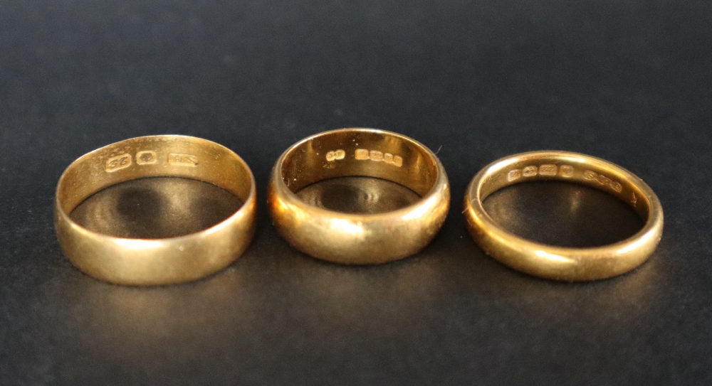 A 22ct yellow gold wedding band, size M 1/2 together with two other 22ct gold wedding bands, - Image 2 of 2