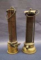A 19th century brass Davy lamp, with an arched top and gauze shield on a screwed on brass base, 24.