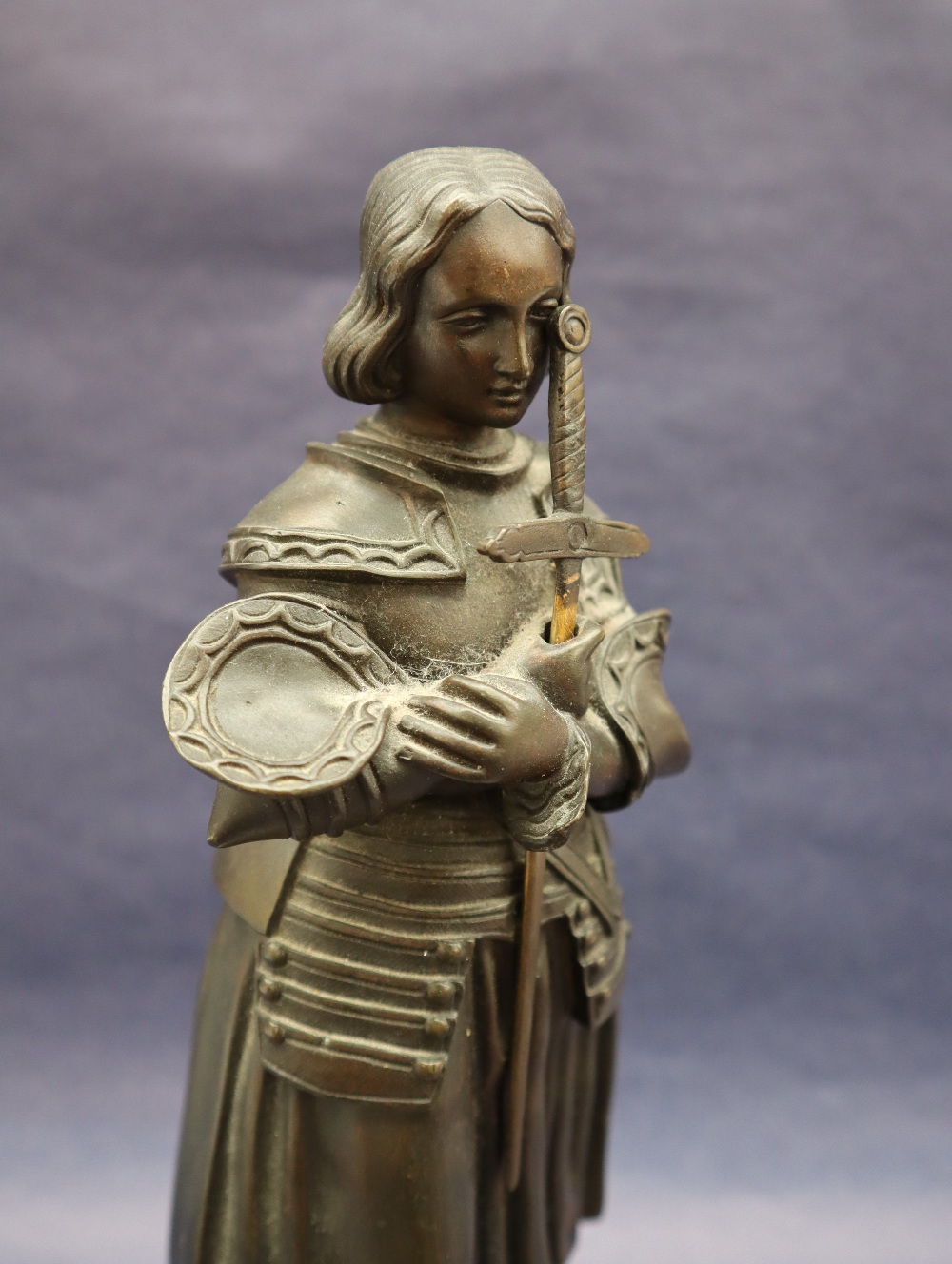 A bronze figure of Joan of Arc, with head bowed clutching a sword, on a circular marble base, 27. - Image 2 of 8
