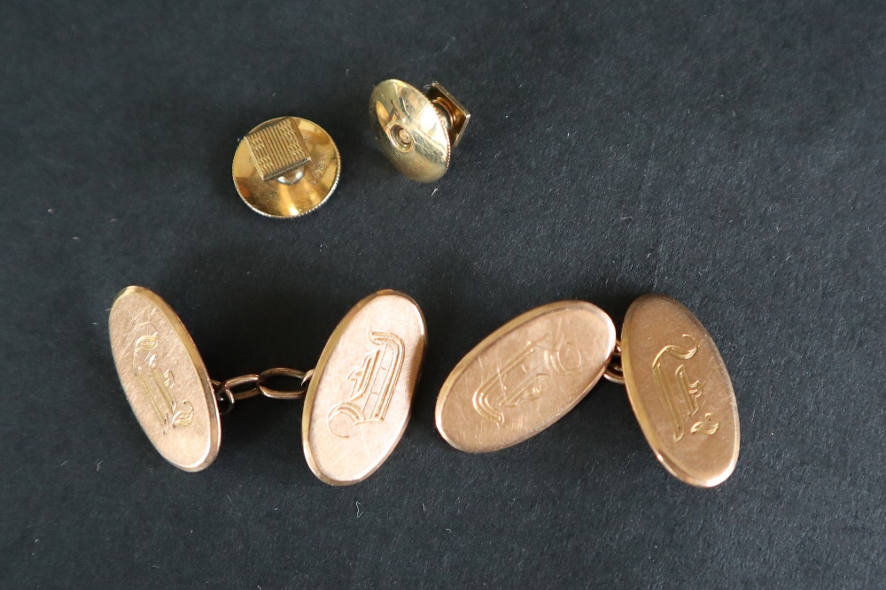 A pair of 9ct gold cufflinks of oval form, initialled together with a pair of 9ct gold shirt studs,