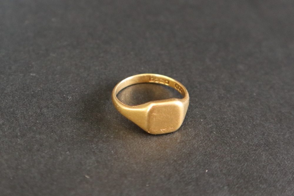 An 18ct yellow gold signet ring with a square shield shaped panel, size N,