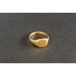 An 18ct yellow gold signet ring with a square shield shaped panel, size N,