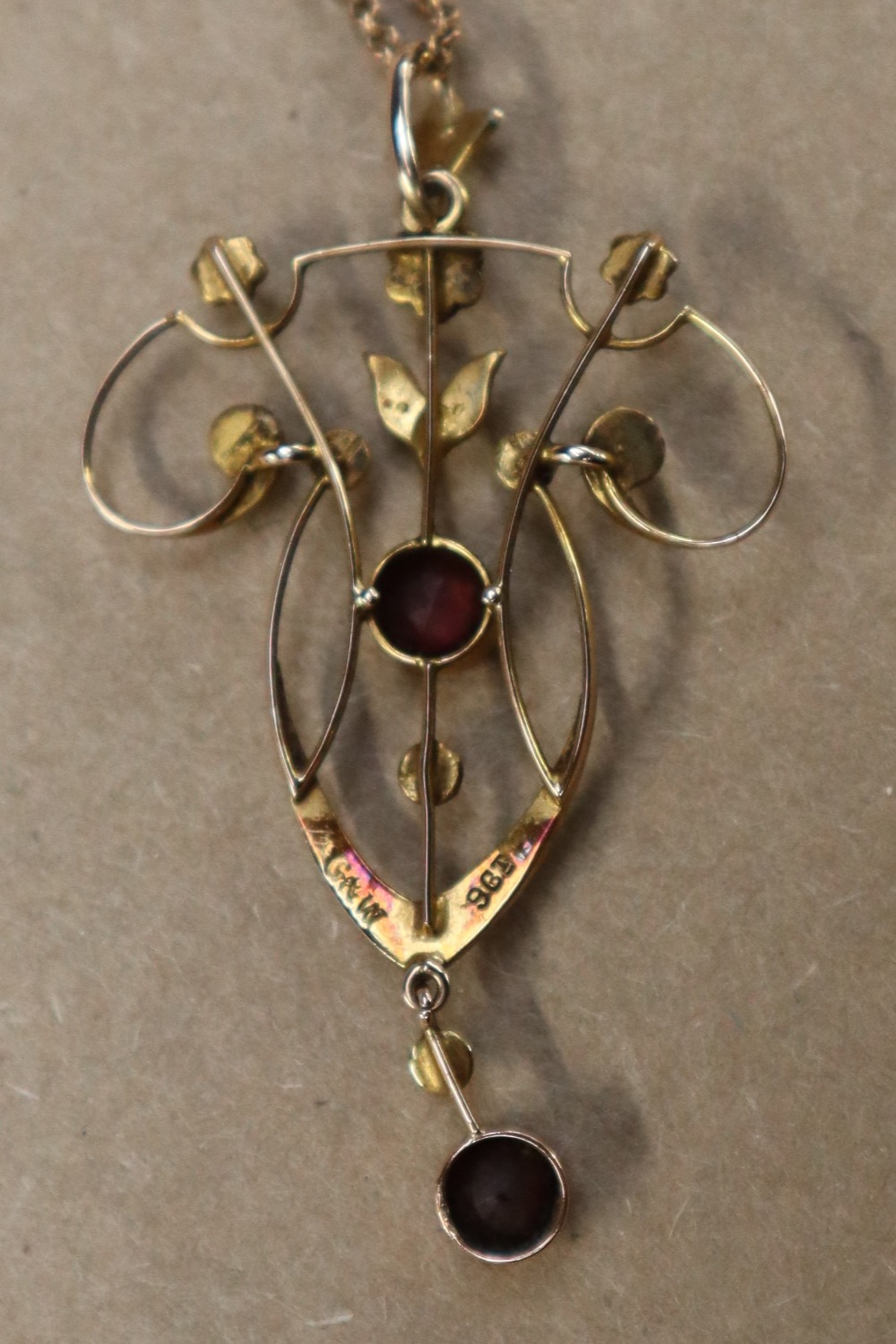 An Edwardian 9ct yellow gold garnet and seed pearl pendant on a 9ct gold chain, - Image 5 of 6