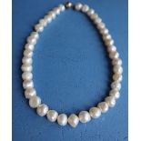 A pearl necklace with forty irregular pearls to a yellow metal ball clasp, 41.