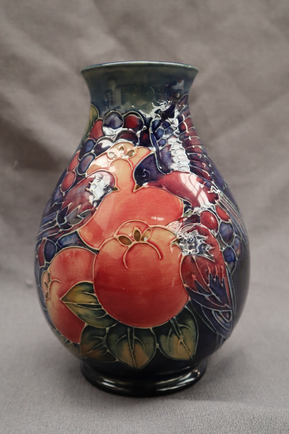 A Moorcroft pottery vase decorated with birds and fruit to a royal blue ground, - Image 4 of 9