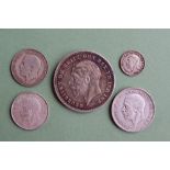 A George V 'Rocking Horse' crown dated 1935 together with four other George V coins including a