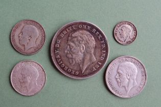 A George V 'Rocking Horse' crown dated 1935 together with four other George V coins including a