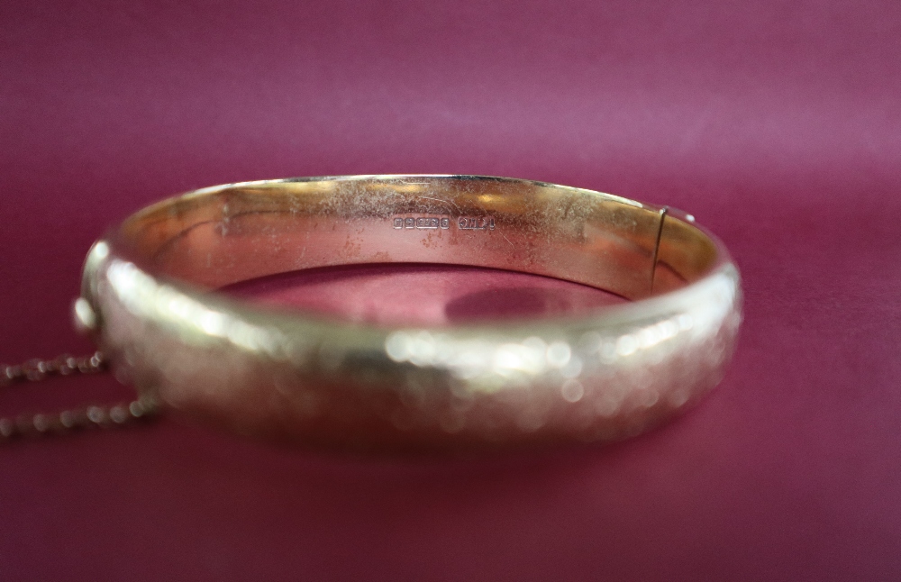 A 9ct yellow gold hinged bangle decorated with scrolls, - Image 3 of 6