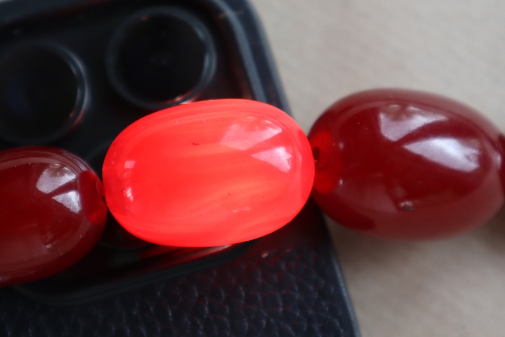 Two Cherry Amber / bakelite bead necklaces, ranging in size from 30mm to 10mm, 79cm long, - Image 12 of 12