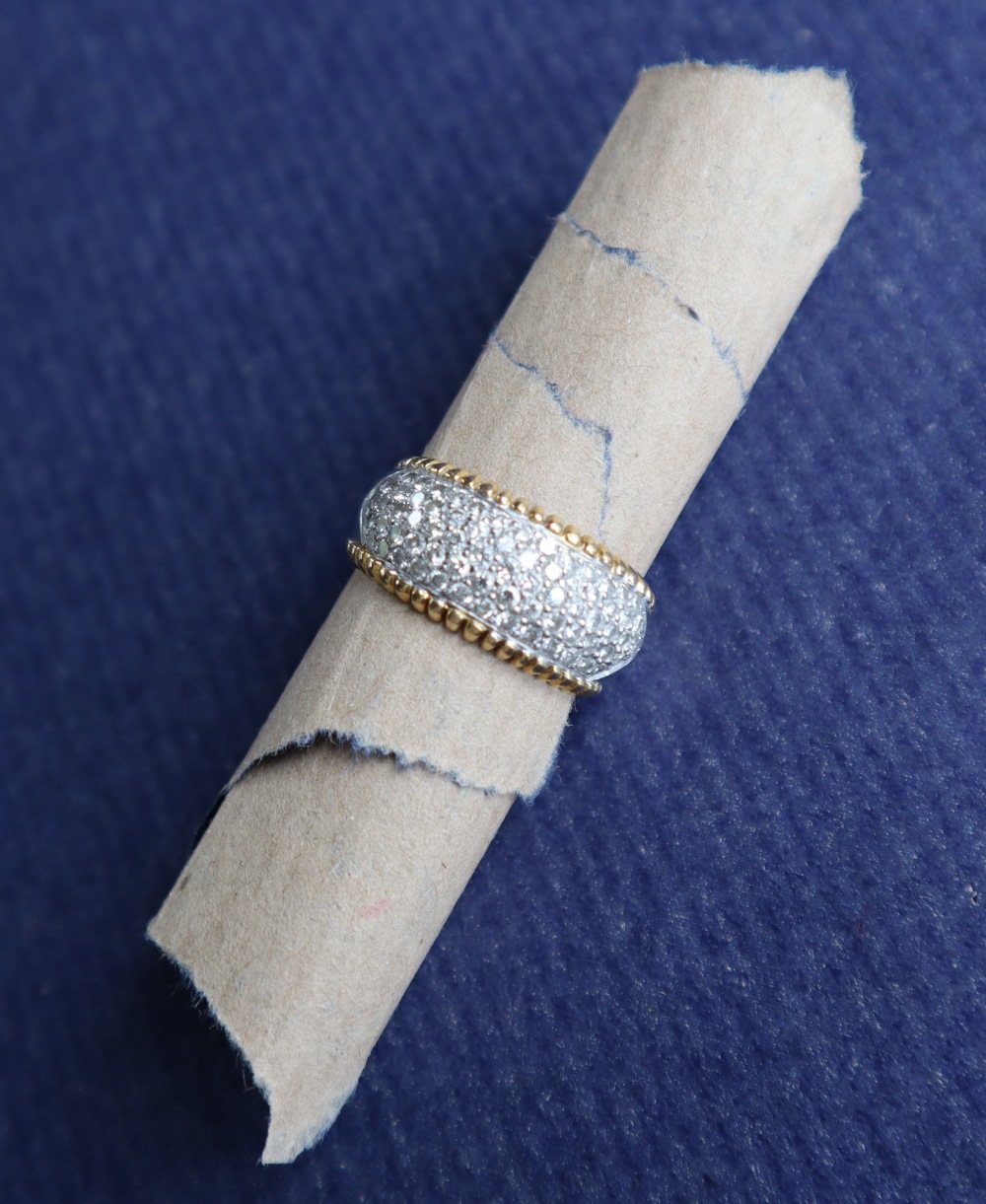 An 18ct yellow and white gold ring, set with a panel of round brilliant cut diamonds, size P, - Image 2 of 8