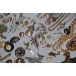 A large collection of costume jewellery including earrings, faux pearl necklaces, rings, medallions,