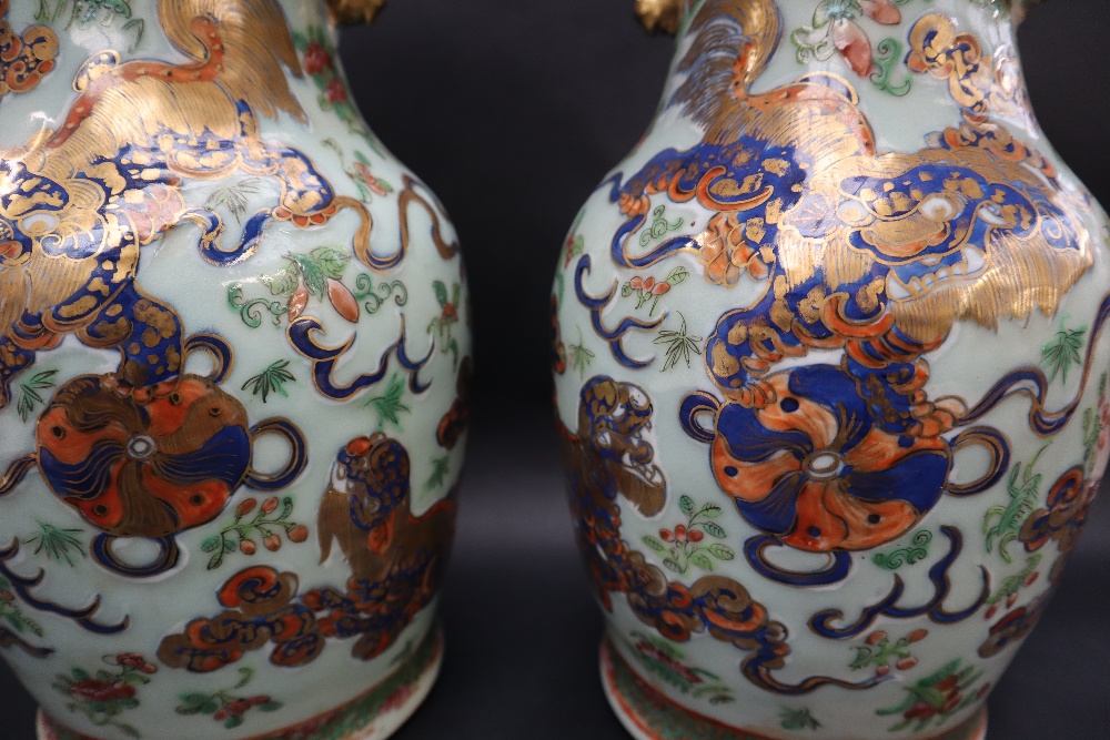 A pair of Cantonese porcelain vases, decorated with a lion dog and ball, - Image 2 of 9