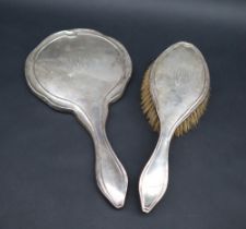 A George V silver backed hand mirror and matching brush, Birmingham, 1920,