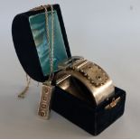 A silver ingot, Sheffield, 1978 on white metal chain, together with a silver buckle hinged bangle,