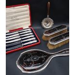 A silver and tortoiseshell mounted hand mirror together with two matching brushes,