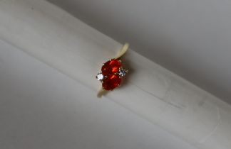An 18ct gold dress ring set with semi precious orange stones possible Spessartite, and diamonds,