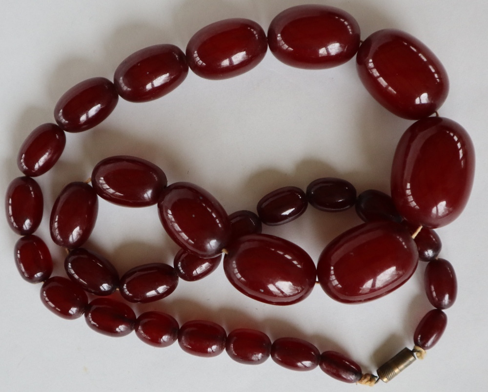 A string of cherry amber / bakelite beads, - Image 8 of 8