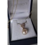 A 9ct yellow gold cultured pearl and diamond inverted pear-shape pendant and chain,