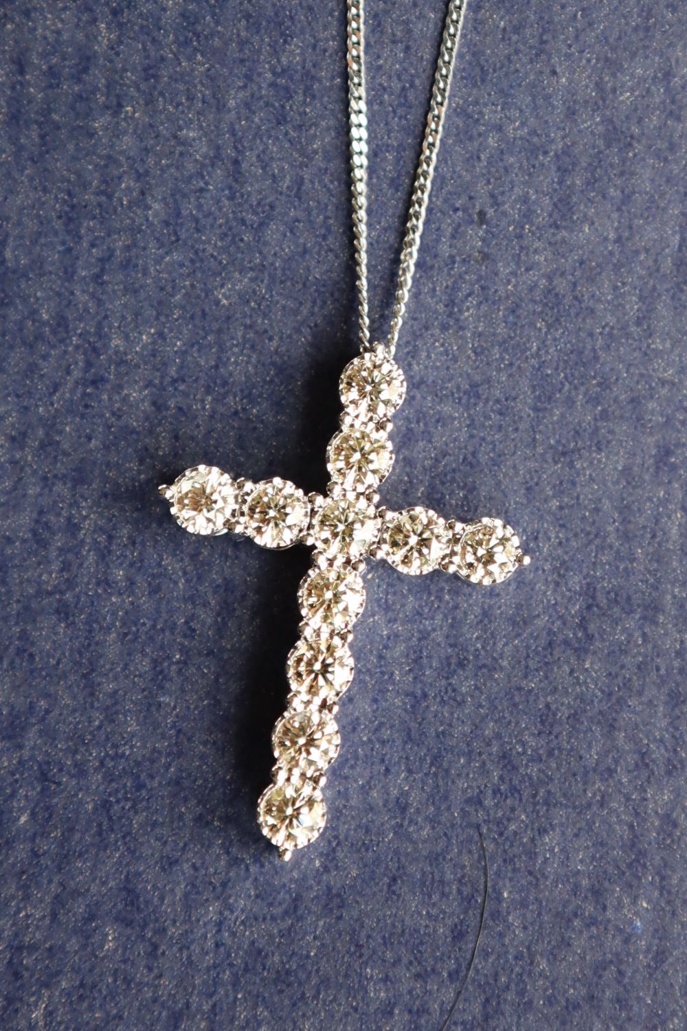 A diamond crucifix set with eleven round brilliant cut diamonds totalling approximately 2.41cts.