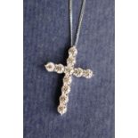 A diamond crucifix set with eleven round brilliant cut diamonds totalling approximately 2.41cts.