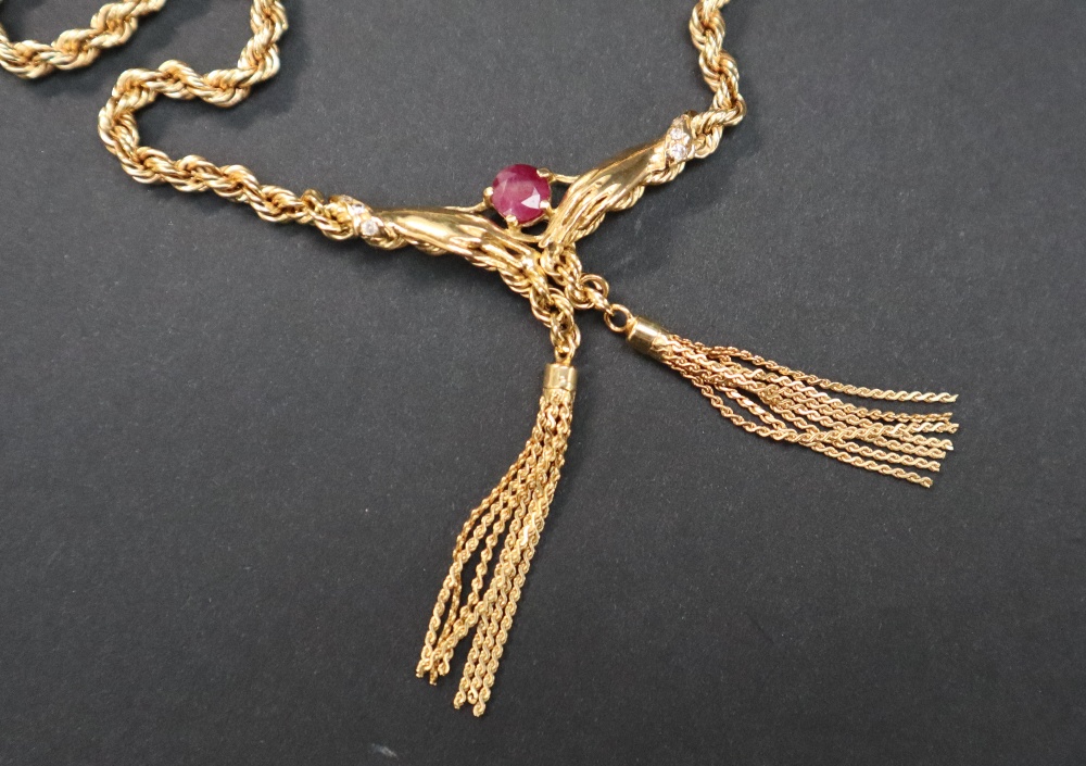 An 18ct yellow gold rope twist necklace, set with a ruby held between hands with tassels underneath, - Image 2 of 4