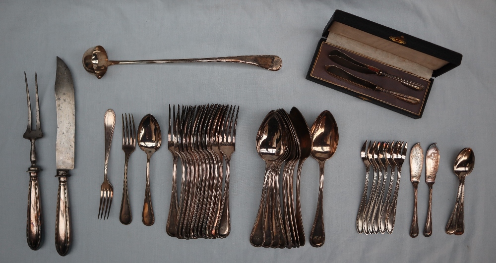 A continental white metal bead decorated part flatware service comprising nine table spoons,