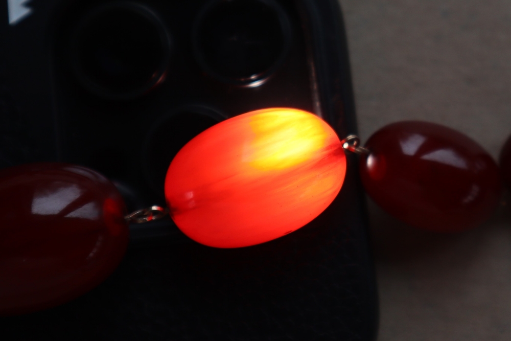 A string of cherry amber / bakelite beads, - Image 9 of 12