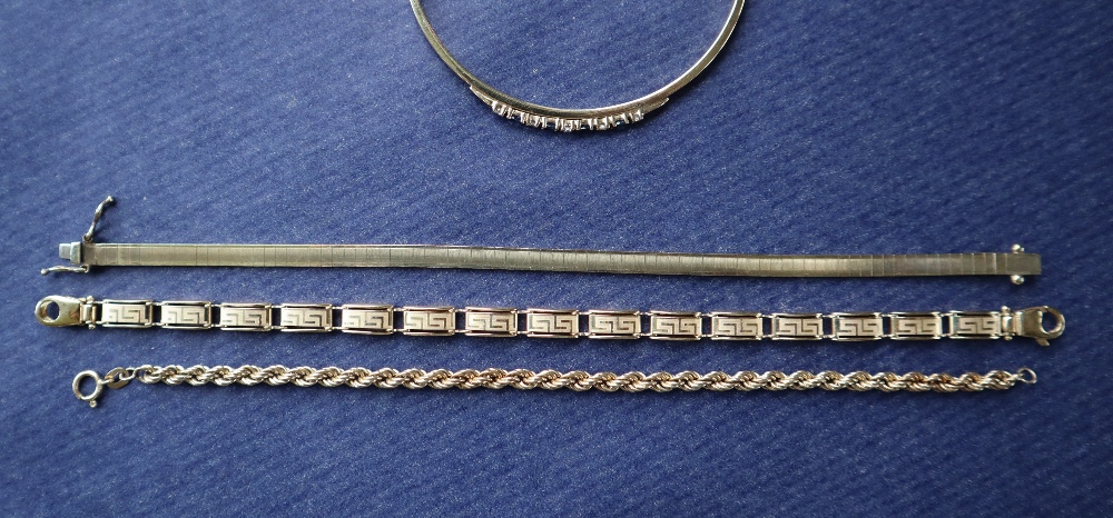 A 9ct gold sapphire and diamond bangle set with four oval faceted sapphires and five round - Image 3 of 3