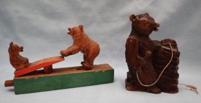 A Black Forest bear childrens toy with a mother and cub on a seesaw together with a bear carving