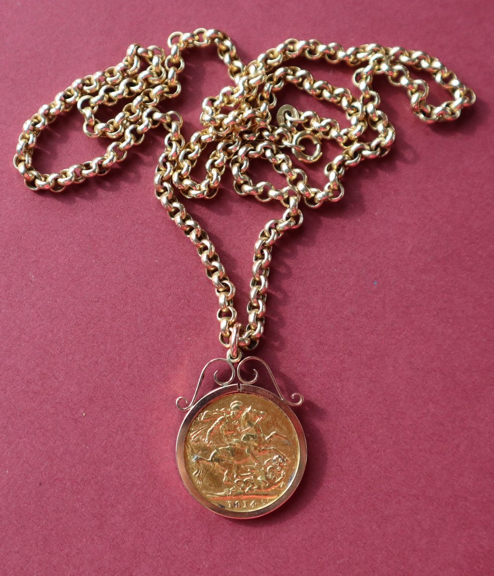 A George V gold sovereign dated 1914 in a 9ct gold slip mount on a 9ct gold chain,