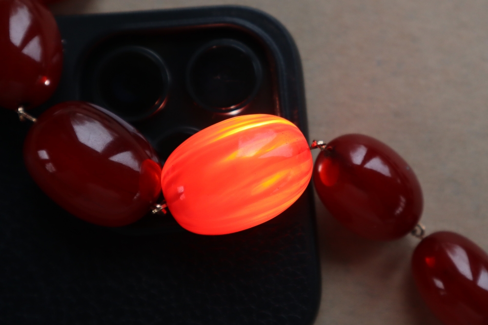 A string of cherry amber / bakelite beads, - Image 8 of 12