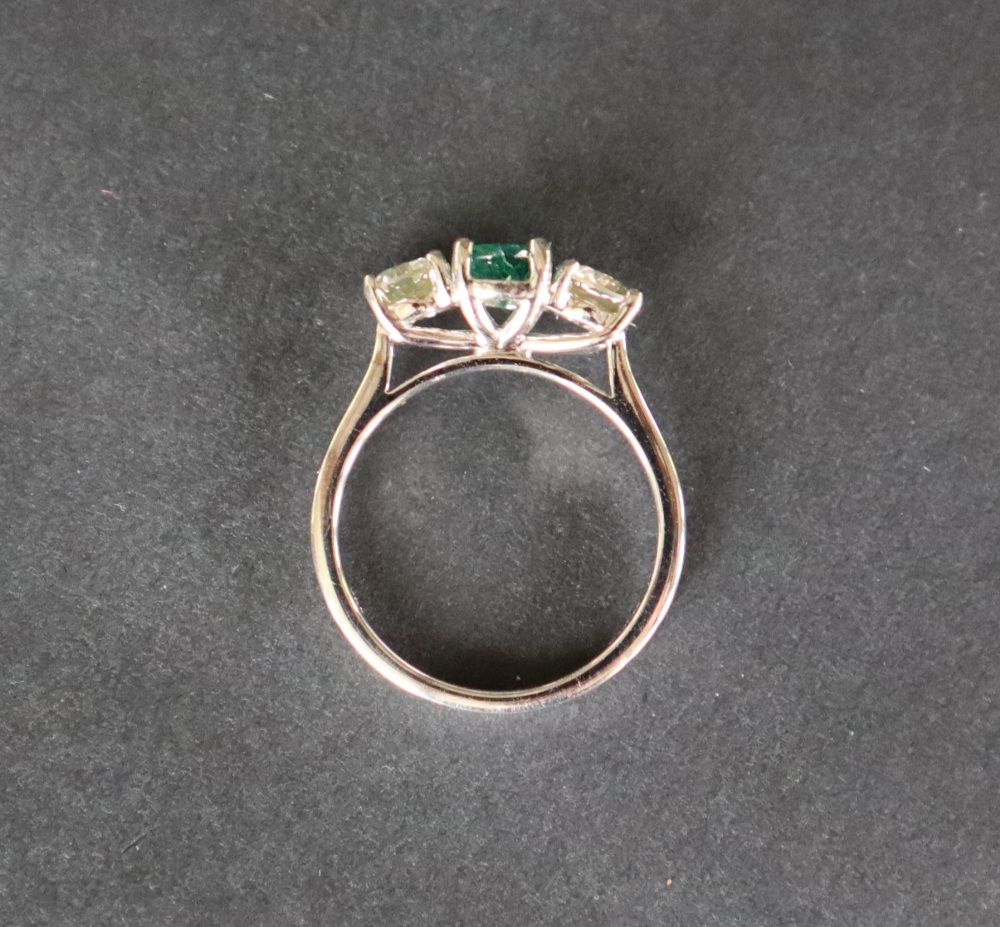 An 18ct white gold emerald and diamond trilogy ring set with an oval faceted emerald approximately - Image 6 of 7