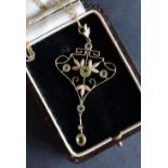 A yellow metal peridot and seed pearl pendant of heart and leaf shape on a yellow metal chain