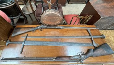 A copper bedwarming pan on a turned handle together with two replica swords and two percussion