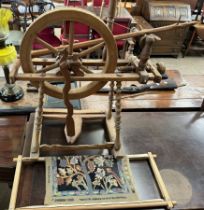 A spinning wheel together with a tapestry and frame