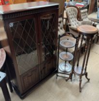 A 20th century oak bookcase together with a folding cake stand and a jardiniere stand