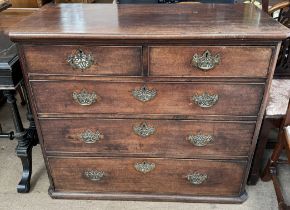 A 19th century mahogany chest with a shaped top above two short and three long drawers on a plinth