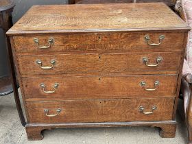 A 19th century oak chest with four long graduated drawers on bracket feet