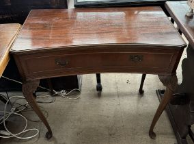 A 20th century mahogany side table with a dished top and single drawer on leaf carved cabriole legs