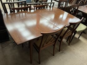 A teak extending dining table and four chairs