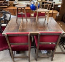 An oak extending dining table together with four dining chairs,