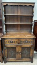 A 20th century oak dresser with a moulded cornice above two shelves,