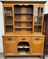 A late Victorian oak kitchen dresser with a moulded cornice with egg and dart decoration above a
