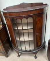 A 20th century mahogany display cabinet with a D shaped top and gadrooned rim above a glazed door