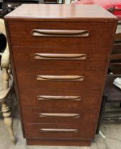 A mid 20th century teak chest of drawers with six drawers on a plinth base
