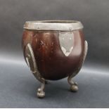 A coconut vase with white metal mounts on three legs,